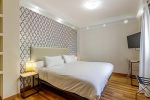 Postel nebo postele na pokoji v ubytování H-A Hotel Trebol