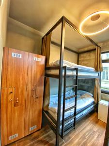 a bunk room with bunk beds and a cabinet at Nomad Hostel Karaköy in Istanbul