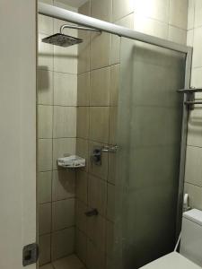a shower with a glass door in a bathroom at Birch tower by matthqueenroom, malate in Manila