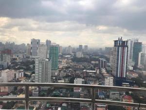 a view of a city skyline with buildings at Birch tower by matthqueenroom, malate in Manila