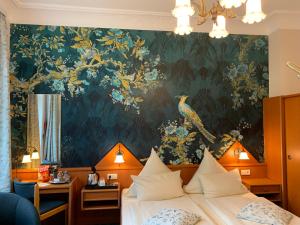 a hotel room with two beds and a wall mural at Hotel Seeufer in Plön