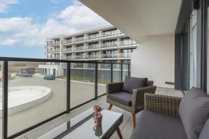 a balcony with a view of a building at Westin House Resort Apartment Kołobrzeg by Noclegi Renters in Kołobrzeg