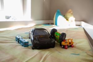 a toy train sitting on top of a bed at Ferienappartement Bachstelze in Erfurt