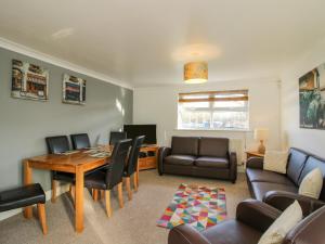a living room with a table and chairs and a couch at Blackwater Meadows in Ellesmere +10 photos