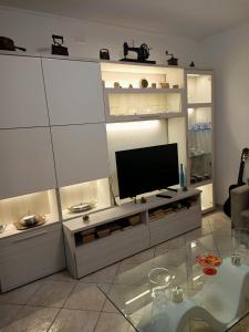 a living room with a flat screen tv on a entertainment center at La casa dei ricordi in Acqualagna