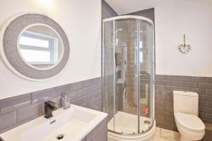 a bathroom with a shower and a sink and a toilet at Apt 1 - Queens Court in Scarborough