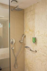 a shower with a shower head in a bathroom at Hotel DeSilva Premium Opole in Opole