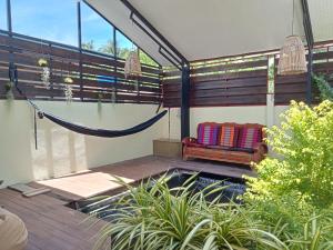 a porch with a hammock and a swing at COWORX Koh Lanta in Ban Mo Nae