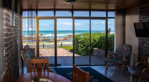 a living room with a view of the ocean at Kormorant in Gansbaai