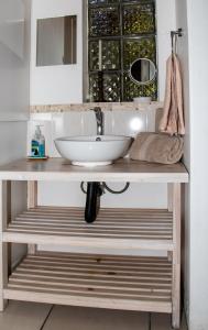 a bathroom with a sink on a wooden counter at Kormorant in Gansbaai