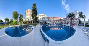 a resort with two pools and chairs and buildings at Flamingo Beach Hotel in Sunny Beach