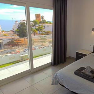 a bedroom with a large window with a view at La Casa De Nu Torremuelle 7 Bed Luxury Villa in Torremuelle