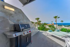 a grill on a patio with a view of the ocean at Ocean View Luxury Apartment PH014 in Adeje