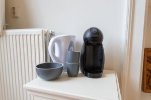 a coffee maker and cups on a counter at De Dekenije in Zutphen