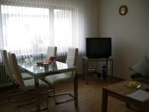 a living room with a table and a television at Ferienwohnung Herrig in Treis-Karden