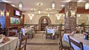 a dining room with tables and chairs in a restaurant at Mountain Lodge Apartments in Pamporovo