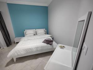 a bedroom with a white bed and a mirror at Sea Dreams @ Hurghada Dreams in Hurghada +19 photos
