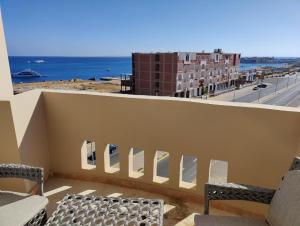 a balcony with chairs and a view of the ocean at Sea Dreams @ Hurghada Dreams in Hurghada
