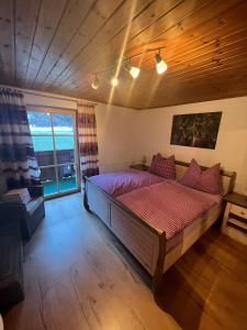 a bedroom with a large bed and a large window at Ferienhaus Niederl in Golling an der Salzach