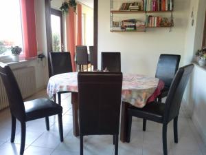 a dining room with a table and chairs and a table and chairsktop at Haus Erika in Bad Sooden-Allendorf +12 photos