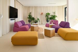 a living room with purple and purple chairs and tables at Seaview Villa Flora - Heated pool and Spa in Omiš