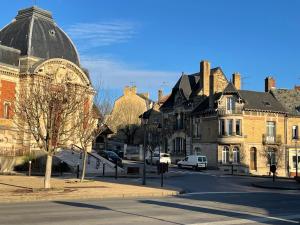 a street in a town with houses and a building at Suites Mana - La Perle des Isles , Superbe maison Art déco avec balnéothérapie in Rethel