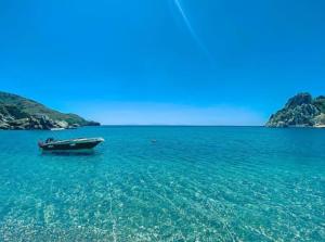 a boat in the middle of a large body of water at Datca Masal Gibi Plaj&Restaurant in Datca