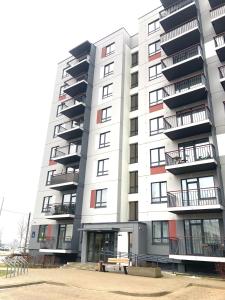 a large apartment building with a bench in front of it at Apartment Upeņu in Rīga