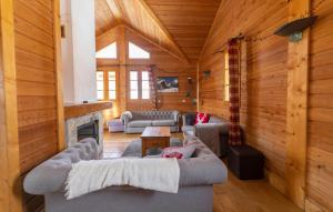 a living room with two couches and a fireplace at Odalys Chalet Diane in L'Alpe-d'Huez