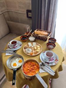 a table with eggs and other food on it at Lakeside Garden - Ismayilli Guest house in İsmayıllı