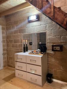 a kitchen with a counter with wine bottles on it at Lakeside Garden - Ismayilli Guest house in İsmayıllı