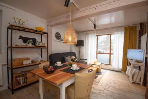 a living room with a wooden table and a dining room at Ferienwohnung Eliese in Suhl in Suhl