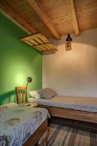 a bedroom with two beds and a green wall at Casa Verde in Catania