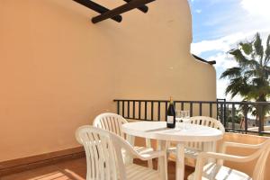 Biały stół i krzesła na balkonie z butelką wina w obiekcie Studio Apt Walking Distance to Beach Wyndham Resor w mieście Mijas Costa +16 zdjęć