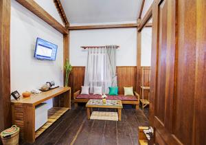 a living room with a couch and a table at Maison Model d'Angkor in Siem Reap