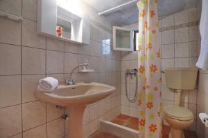 a bathroom with a sink and a toilet and a shower curtain at Skopelos Mortero Cottage in Panormos Skopelos