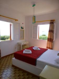 a bedroom with a bed with two towels on it at Arokaria Seaside in Ambelas