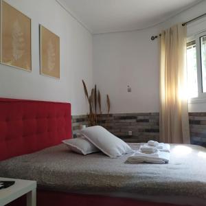 a bedroom with a bed with two towels on it at PremiumGuestKifissia in Athens