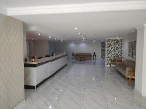 a lobby with a reception desk and couches in a building at Via Venetto Flat Fortaleza Bera mar Meireles in Fortaleza +130 photos