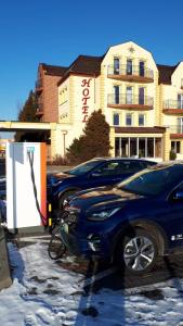 una fila de coches aparcados frente a un hotel en Grand Częstochowa, en Częstochowa