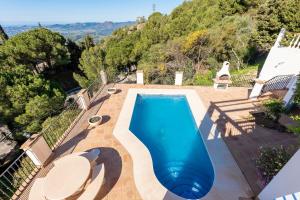 a swimming pool in the middle of a patio at Villa with Stunning Views & Private Pool in Mijas Costa