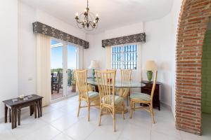 a dining room with a table and chairs at Villa with Stunning Views & Private Pool in Mijas Costa