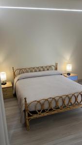 un letto in una camera da letto con due comodini e due lampade di Casa Don Vicenzo a Randazzo