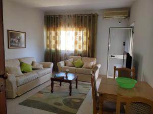 a living room with a couch and a table at Apartament 1+1 Plazh Durrës in Durrës