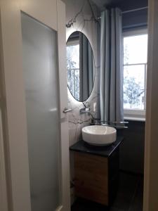 a bathroom with a sink and a mirror at Villa Malinka in Karpacz