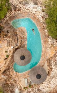 an overhead view of a swimming pool with a snake shaped pool at Vingerklip Lodge in Vingerklip