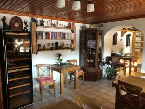 a dining room with a table and chairs and shelves at Penzion Relax in Prievidza