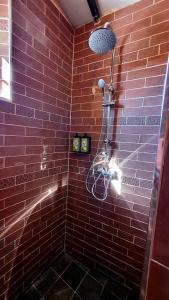 a red tiled shower with a blow dryer at La Estación del Amor in Alora