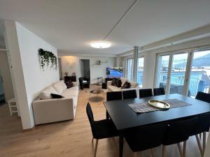 a living room with a table and a couch at Ferienwohnung Rütiboda 8-10 Personen in Davos