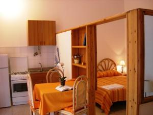 a kitchen with a bedroom with a bunk bed at Case Vacanze Arcobaleno in Lipari